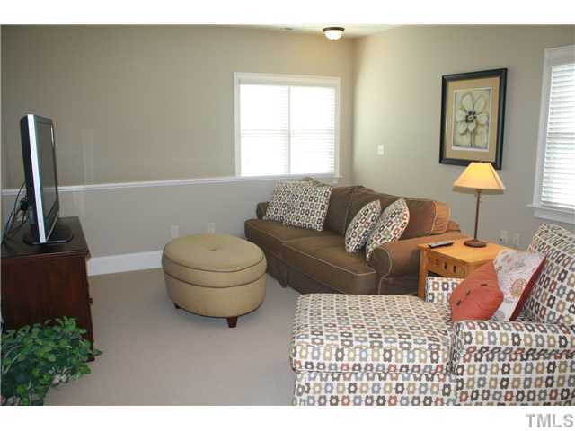 2812 Winter Song Road Raleigh, NC 27614 - Photo 14 of 24 This spacious bonus room has both a back stairs entry as well as hall access. Room features a built-in desk area with cabinets & file drawers to create the perfect work area or hobby space. Room features berber carpet and a ceiling fan for added comfort.