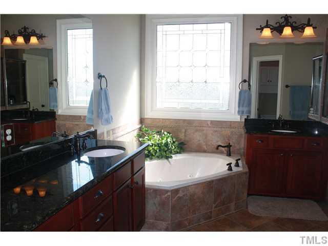 2812 Winter Song Road Raleigh, NC 27614 - Photo 18 of 24 This spa-like master bath features a whirlpool tub and separate shower with tile surround. Room boasts an etched glass window, upgraded cabinets with granite counter-tops, and his and hers vanities.