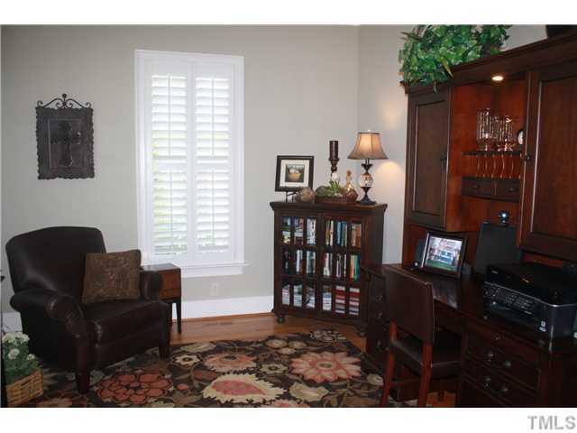 2812 Winter Song Road Raleigh, NC 27614 - Photo 5 of 24 The formal living room is currently being used as an office. This spacious room boasts crown molding, hardwood flooring, plantation shutters, smooth ceilings, and a French door entry with a transom window above.