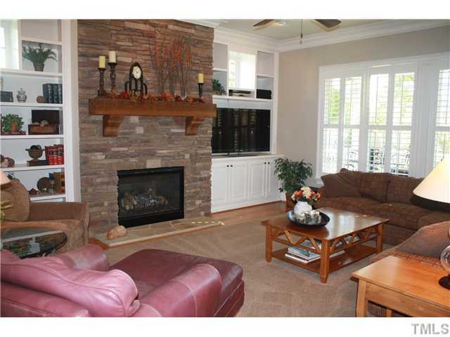 2812 Winter Song Road Raleigh, NC 27614 - Photo 6 of 24 This beautiful and elegant family room is open to the kitchen, and features a wall of windows which are graced with plantation shutters. The stacked stone fireplace with a wooden mantle is the focal point of this lovely room.