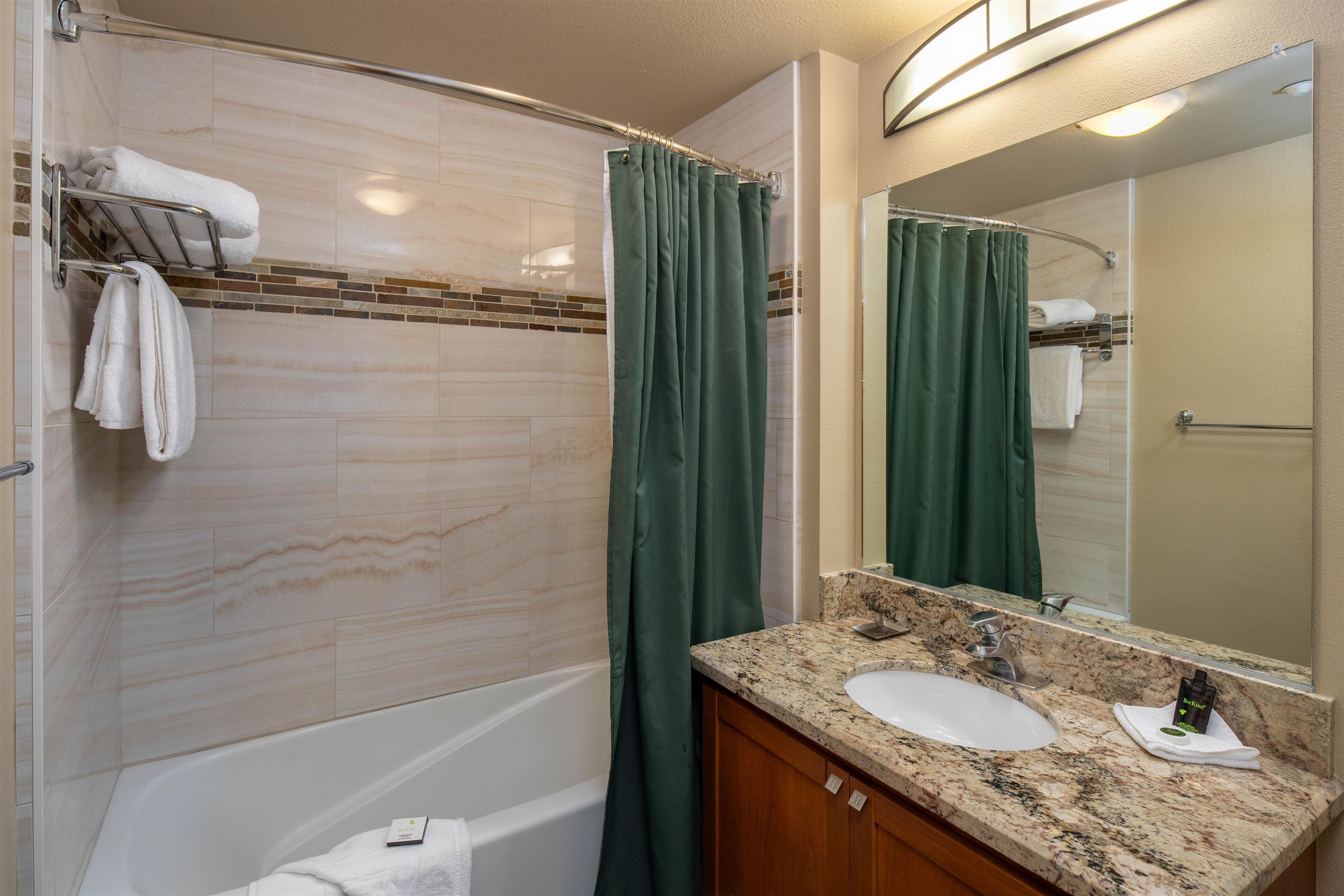 1985 Olympic Vly Road, Unit 2424 Olympic Valley, CA 96146 - Photo 15 of 21 a bathroom with a granite countertop sink a mirror and shower