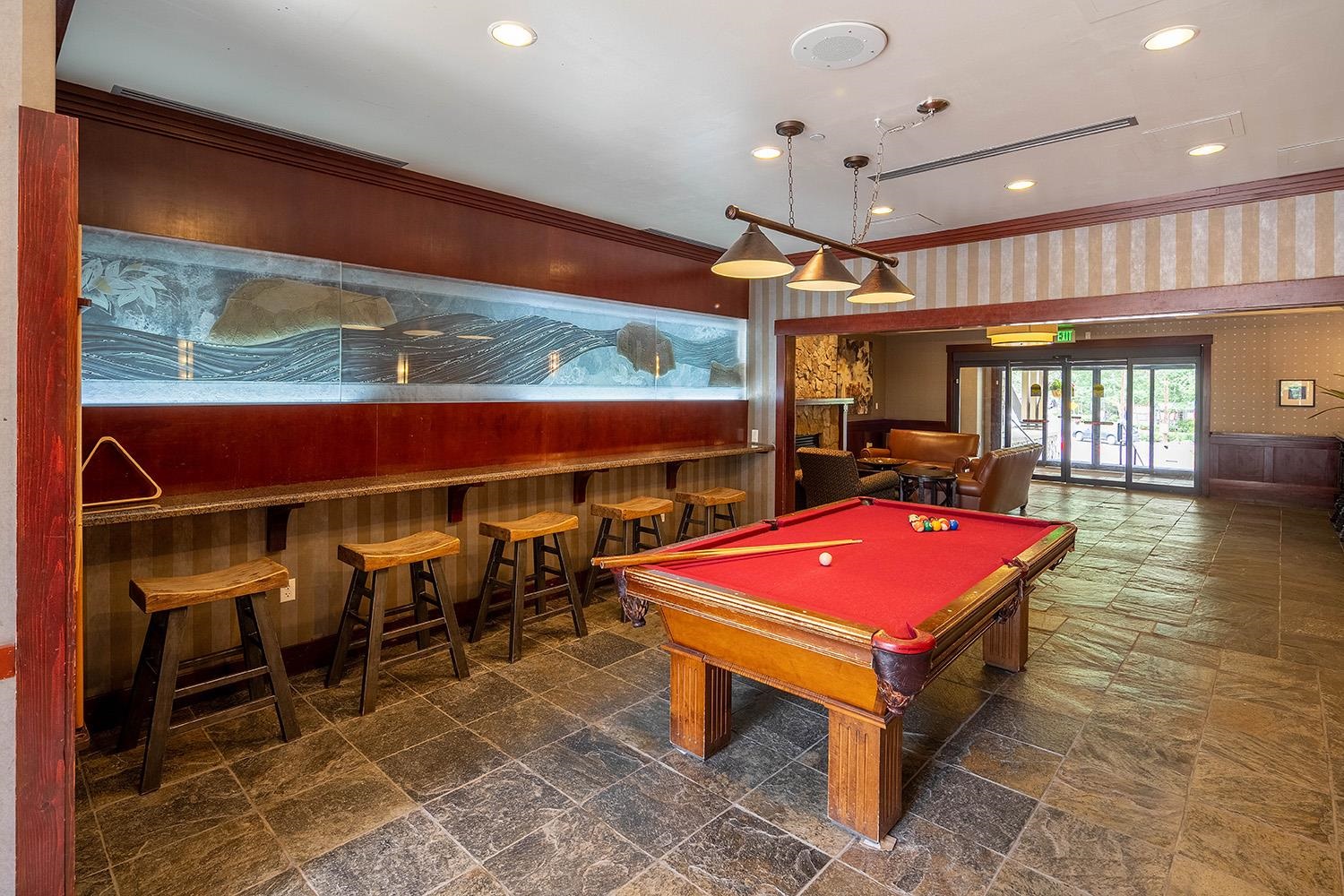 1985 Olympic Vly Road, Unit 2424 Olympic Valley, CA 96146 - Photo 16 of 21 a living room with furniture a pool table and a fireplace
