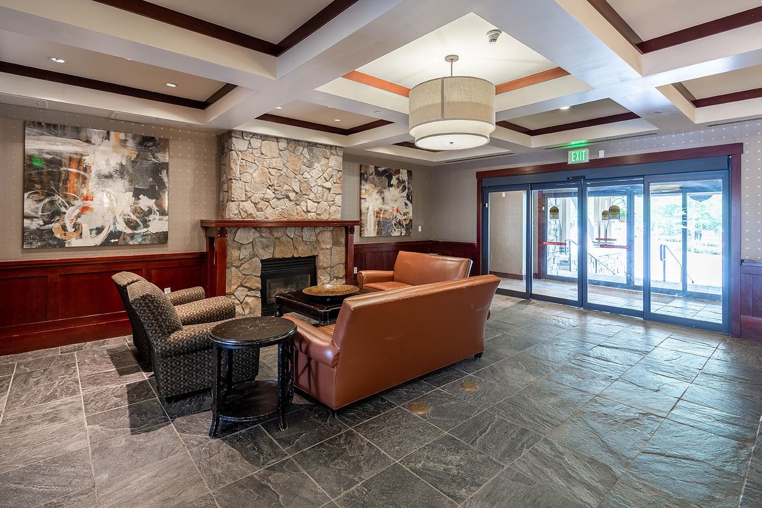 1985 Olympic Vly Road, Unit 2424 Olympic Valley, CA 96146 - Photo 17 of 21 a living room with furniture a fireplace and a large window
