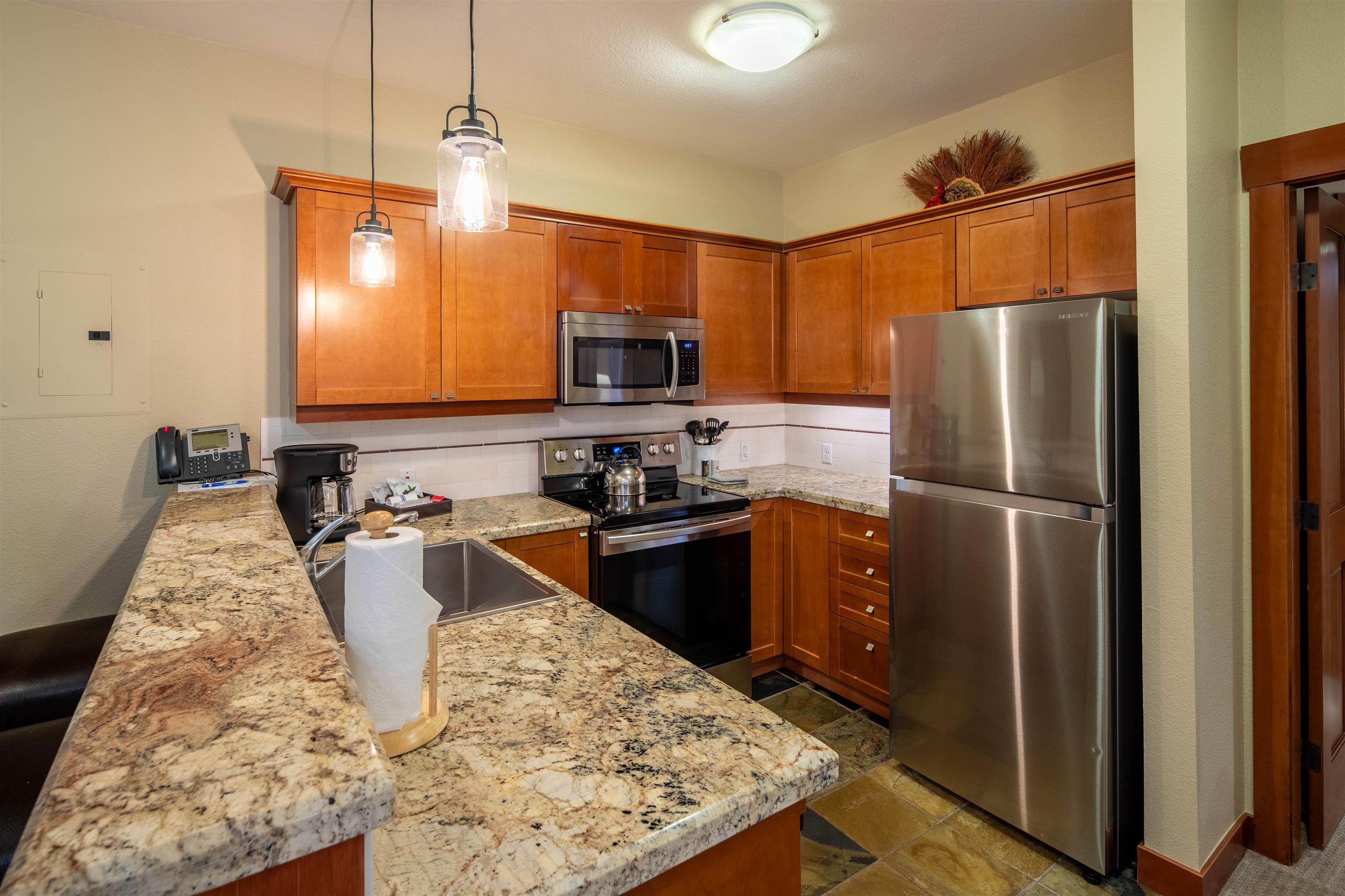 1985 Olympic Vly Road, Unit 2424 Olympic Valley, CA 96146 - Photo 7 of 21 a kitchen with stainless steel appliances granite countertop a refrigerator and a stove top oven