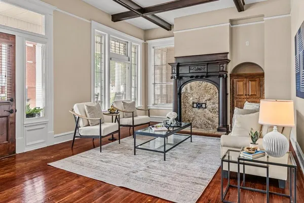 a living room with furniture a chandelier and a window