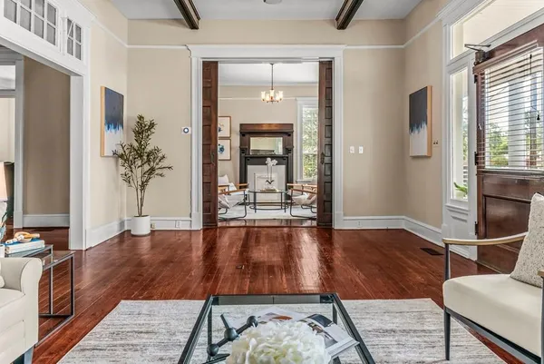 a living room with furniture and a chandelier