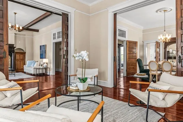 a dining room with furniture a window and chandelier