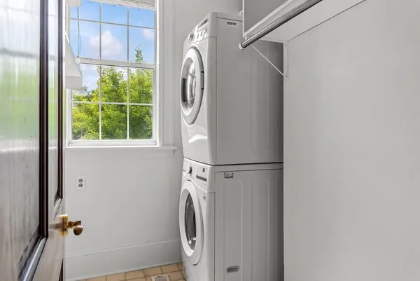 a kitchen with granite countertop white cabinets and a stainless steel appliances