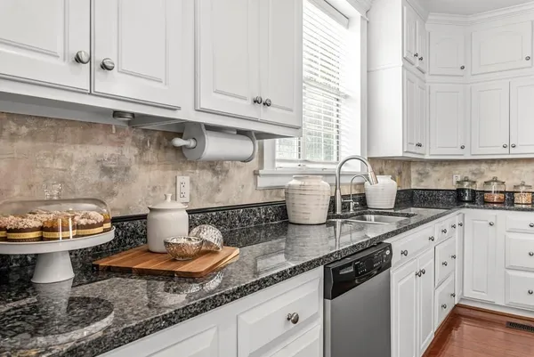 a kitchen with stainless steel appliances granite countertop a refrigerator and a stove