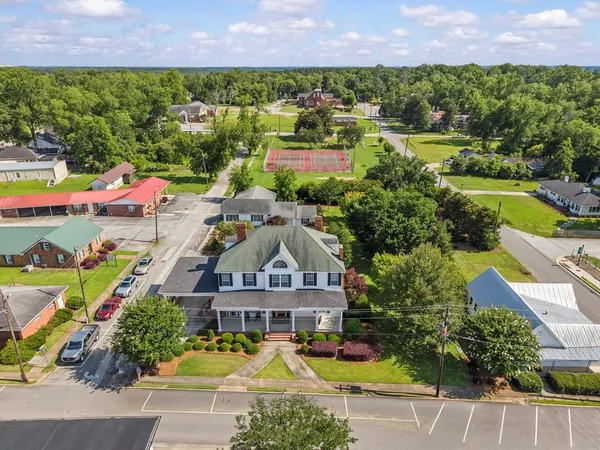 an aerial view of a house with a swimming pool