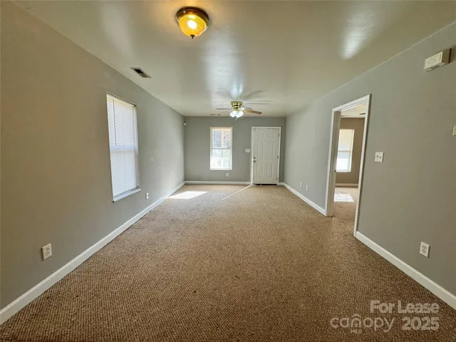 an empty room with windows and closet