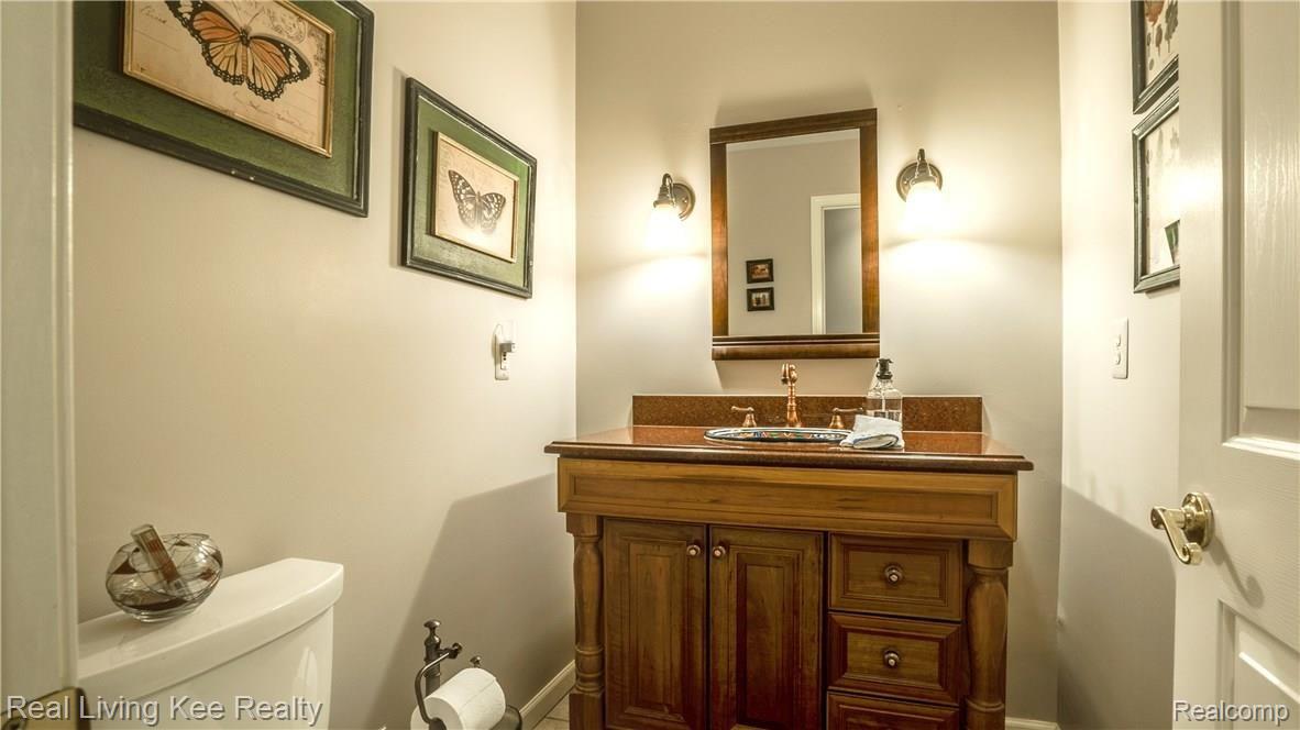 247 Whims Court Rochester, MI 48306 - Photo 43 of 57 First floor powder room is centrally located and has a beautiful vanity.