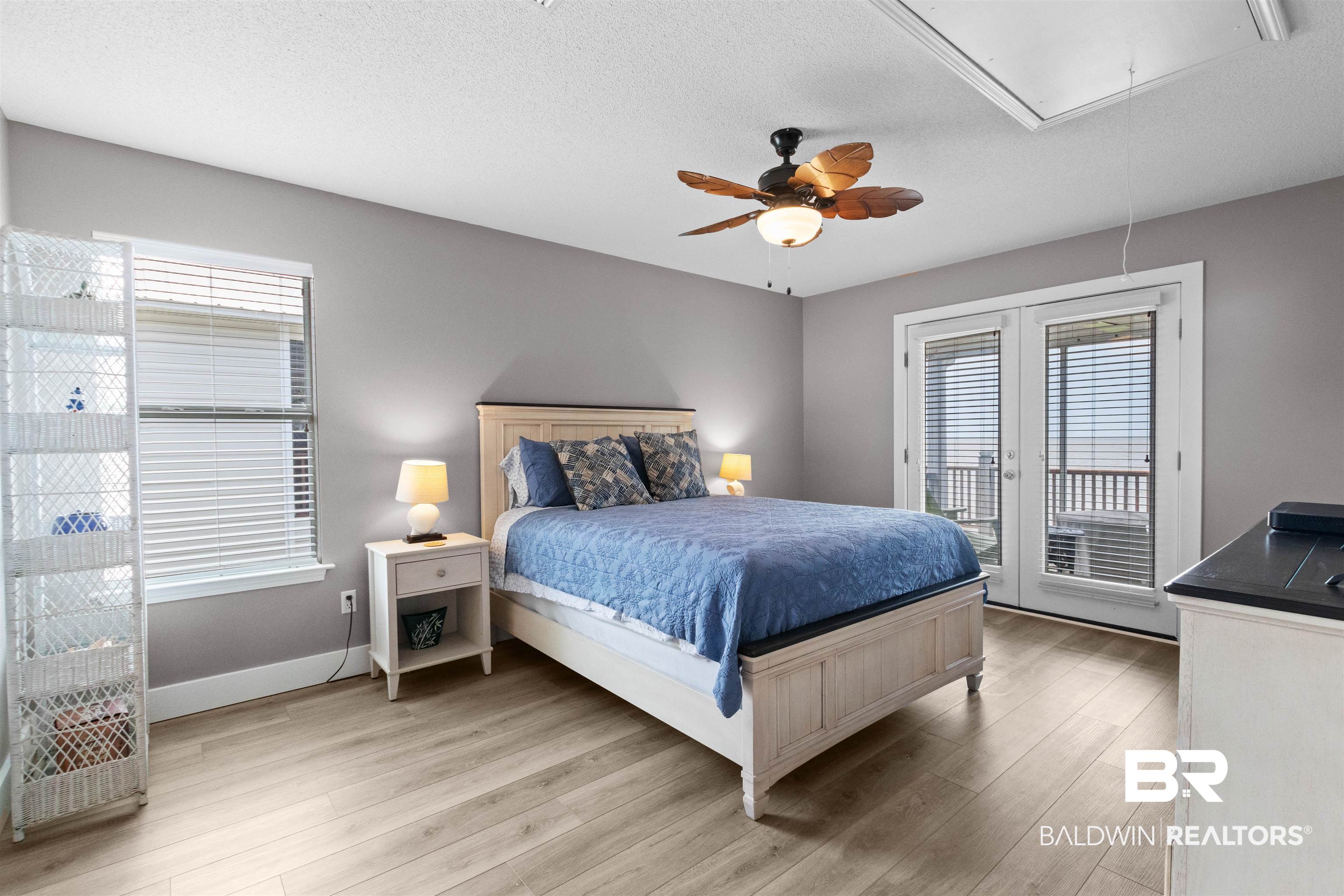 9581 South Bay Street Foley, AL 36535 - Photo 20 of 44 Bedroom with wood-finish flooring, a ceiling fan, and painted gray walls