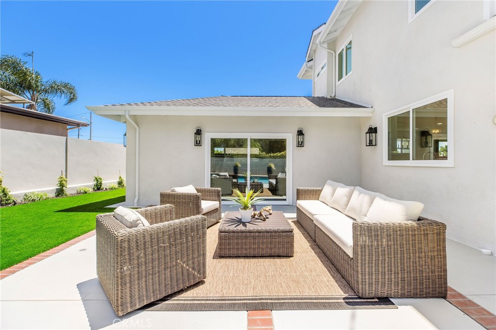 245 Surf Place Seal Beach, CA 90740 - Photo 11 of 65 a view of a patio with couches and potted plants