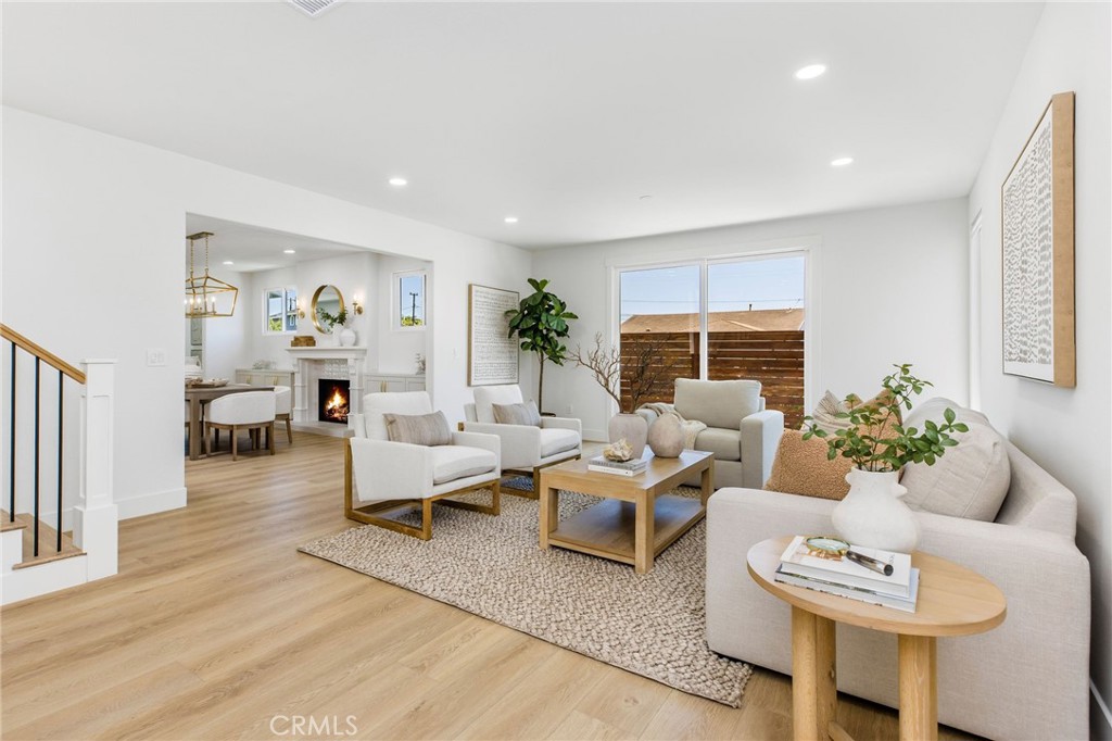 245 Surf Place Seal Beach, CA 90740 - Photo 16 of 65 a living room with furniture and a large window