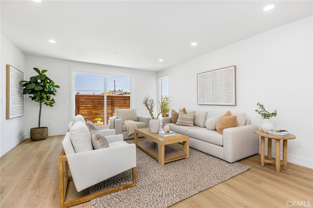 245 Surf Place Seal Beach, CA 90740 - Photo 17 of 65 a living room with furniture potted plant and a window