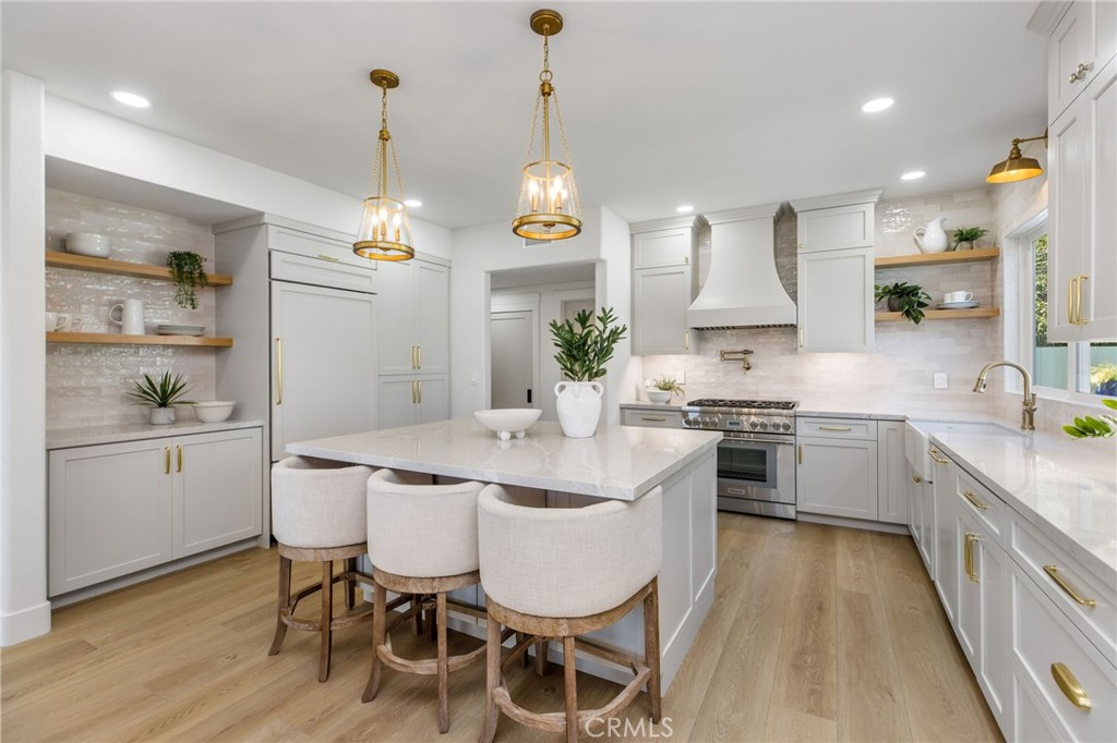 245 Surf Place Seal Beach, CA 90740 - Photo 20 of 65 a kitchen with stainless steel appliances kitchen island granite countertop a sink and cabinets
