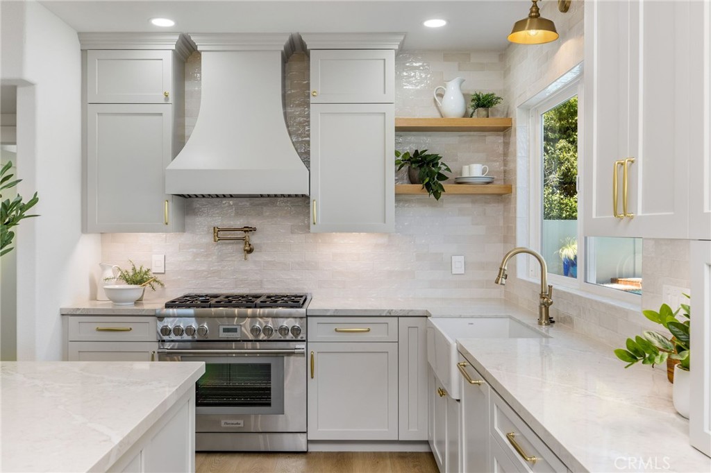 245 Surf Place Seal Beach, CA 90740 - Photo 21 of 65 a kitchen with stainless steel appliances a sink a stove and a refrigerator