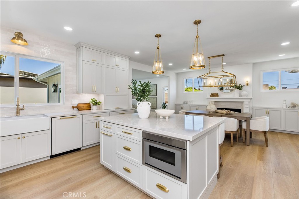 245 Surf Place Seal Beach, CA 90740 - Photo 23 of 65 a kitchen with a sink stove and wooden floor