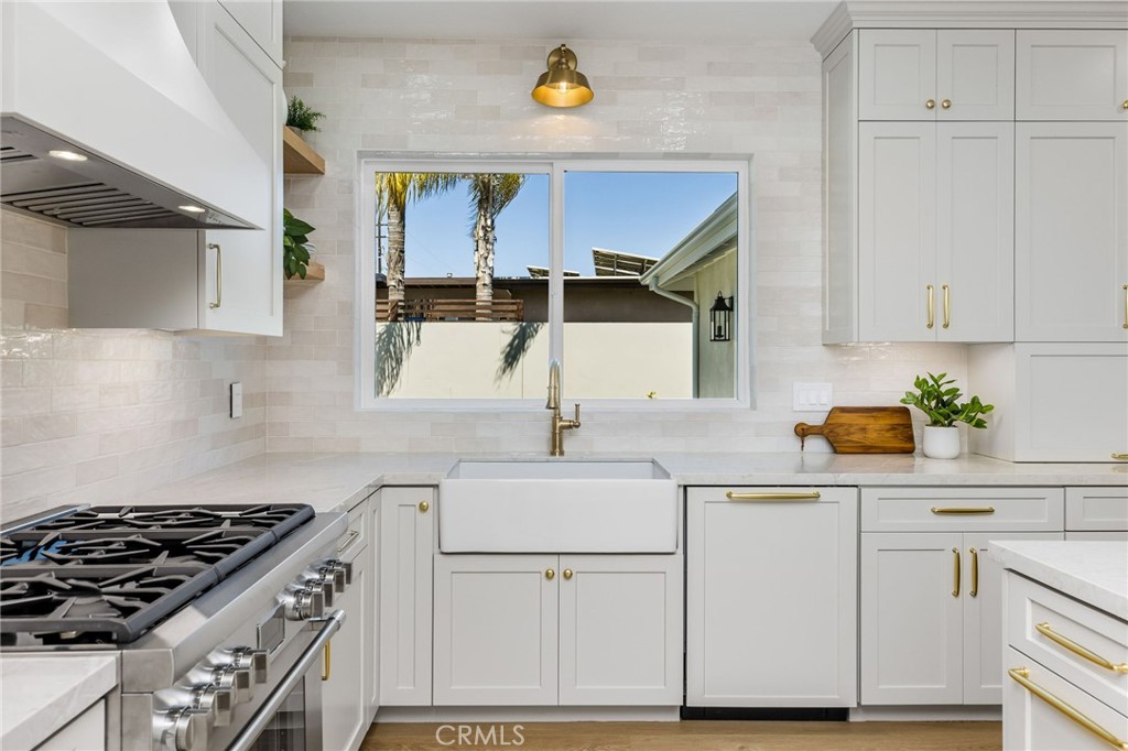 245 Surf Place Seal Beach, CA 90740 - Photo 25 of 65 a kitchen with cabinets and appliances
