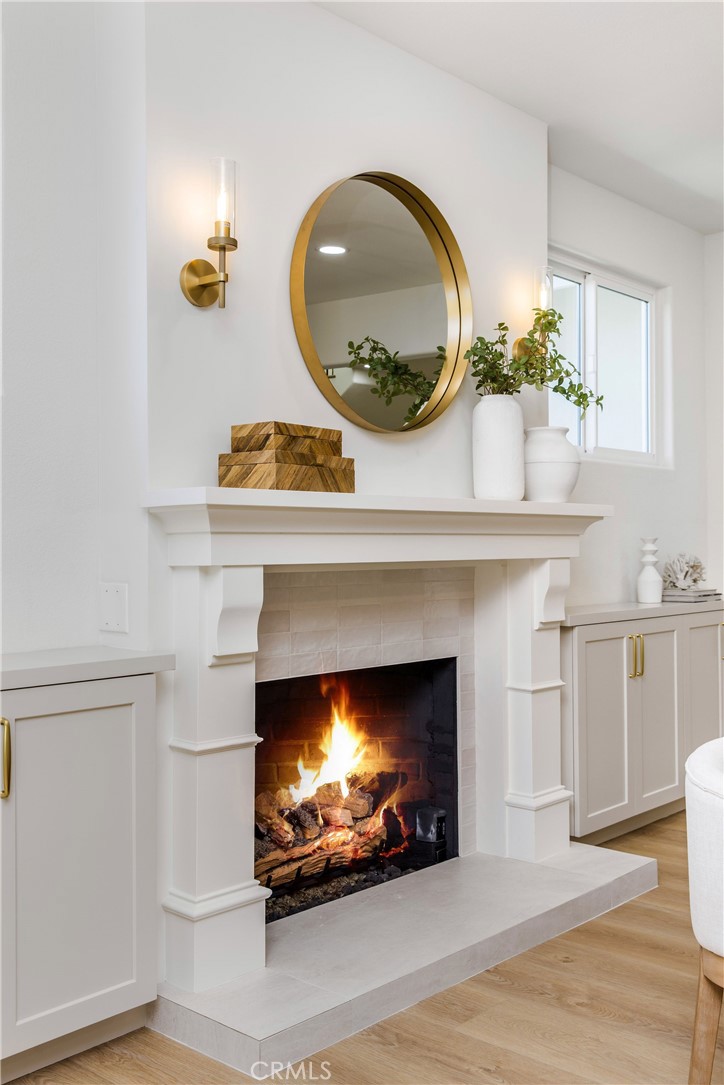 245 Surf Place Seal Beach, CA 90740 - Photo 29 of 65 a fireplace with a clock and a fireplace