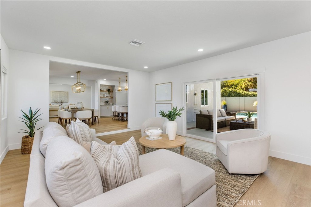 245 Surf Place Seal Beach, CA 90740 - Photo 32 of 65 a living room with furniture and a large window