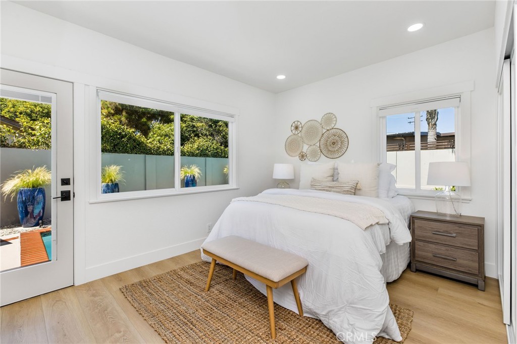 245 Surf Place Seal Beach, CA 90740 - Photo 33 of 65 a bedroom with a bed and a window