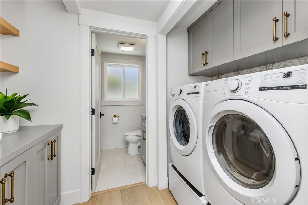 245 Surf Place Seal Beach, CA 90740 - Photo 37 of 65 a view of a hallway with washer and dryer