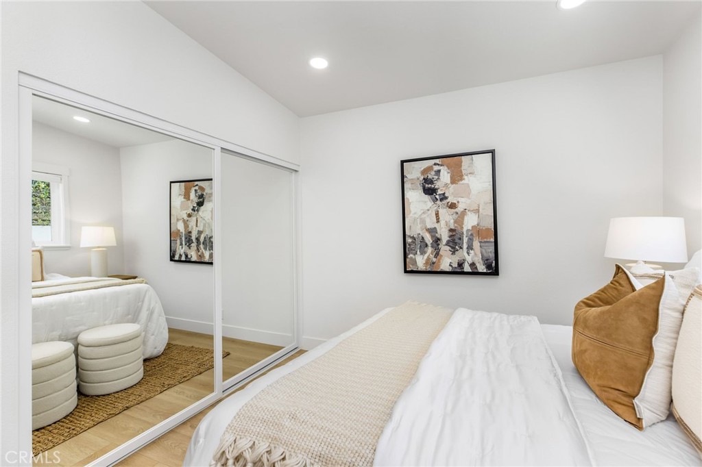 245 Surf Place Seal Beach, CA 90740 - Photo 41 of 65 a bedroom with a bed and a couch