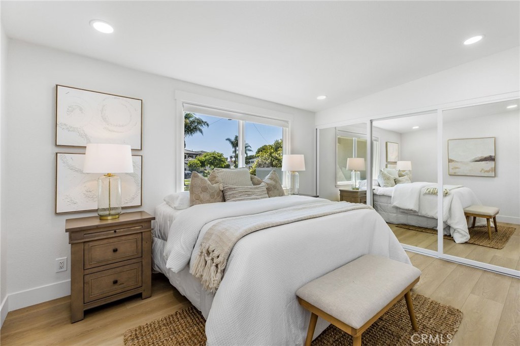 245 Surf Place Seal Beach, CA 90740 - Photo 42 of 65 a bed room with a bed and a night stand