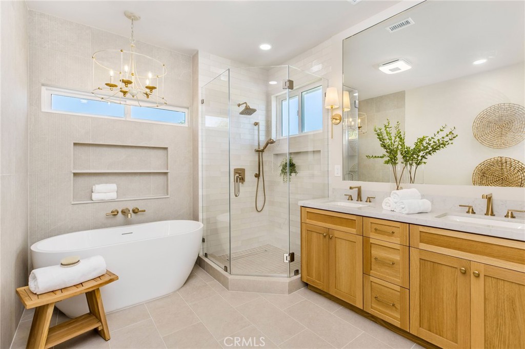 245 Surf Place Seal Beach, CA 90740 - Photo 49 of 65 a spacious bathroom with a double vanity sink tub and mirror