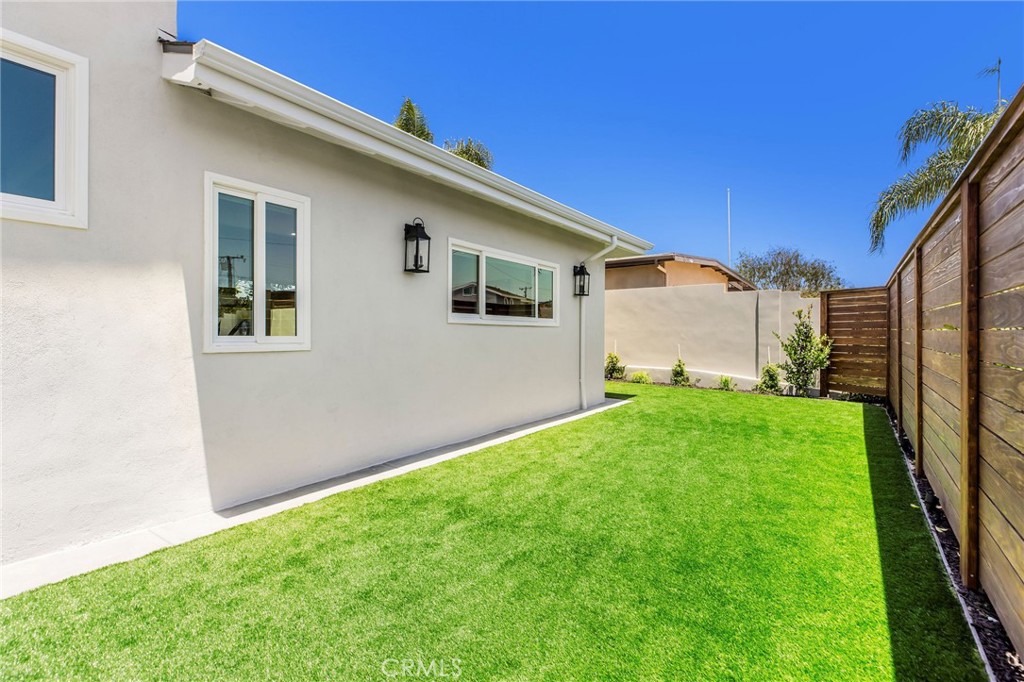 245 Surf Place Seal Beach, CA 90740 - Photo 58 of 65 a backyard of a house with lots of green space