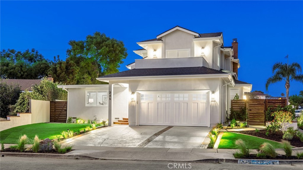 245 Surf Place Seal Beach, CA 90740 - Photo 63 of 65 a front view of a house with a yard and garage