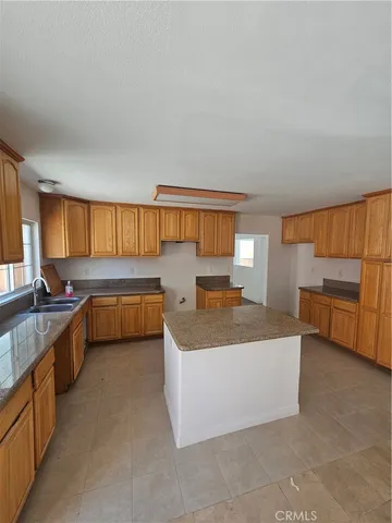 a kitchen with a sink a counter top space and appliances