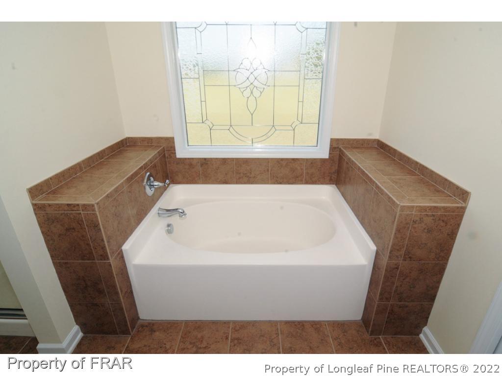 2886 Wade-Stedman Road Stedman, NC 28391 - Photo 12 of 26 a bathroom with a bathtub