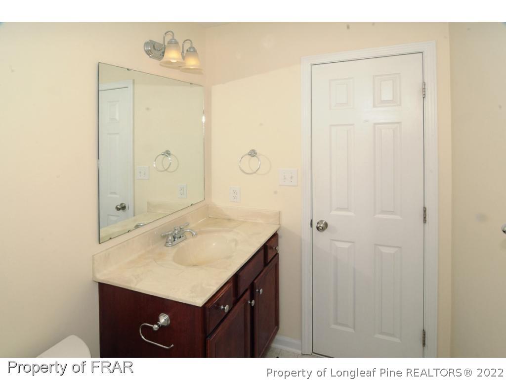 2886 Wade-Stedman Road Stedman, NC 28391 - Photo 15 of 26 a bathroom with a sink vanity and a mirror