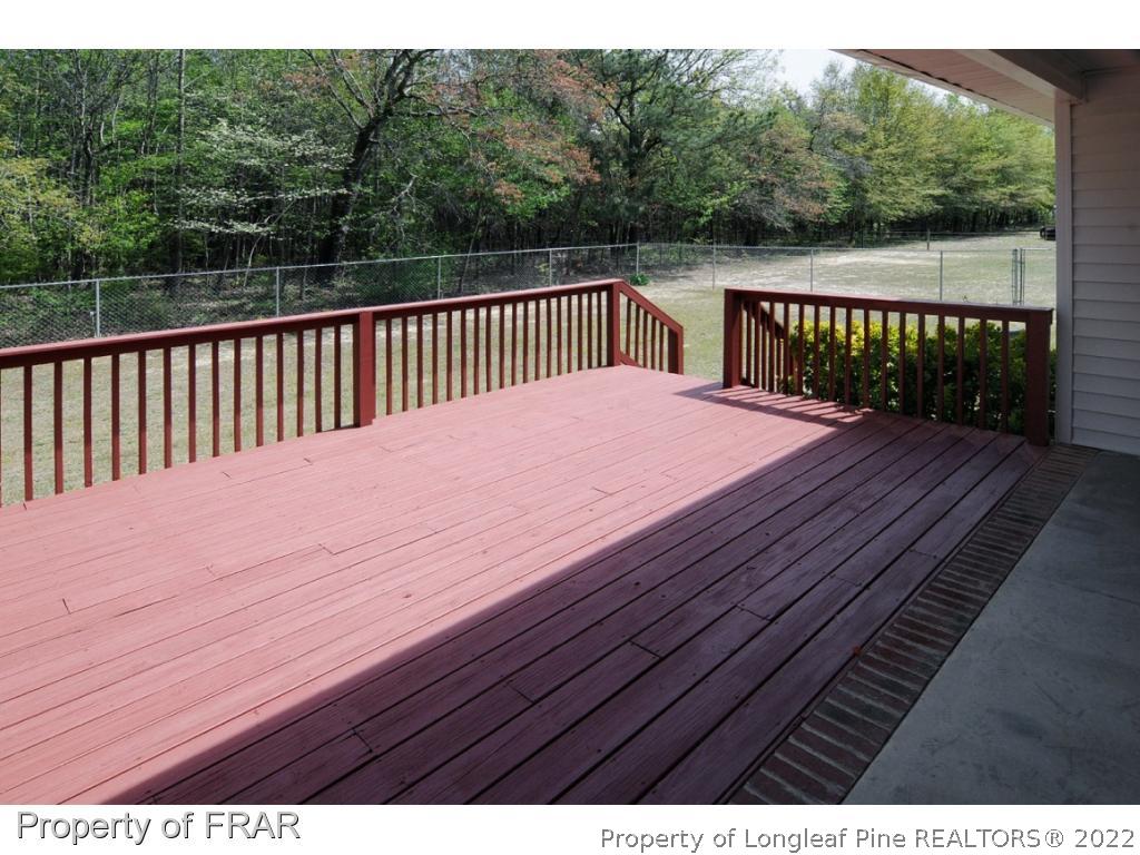 2886 Wade-Stedman Road Stedman, NC 28391 - Photo 19 of 26 a terrace view with wooden floor and fence