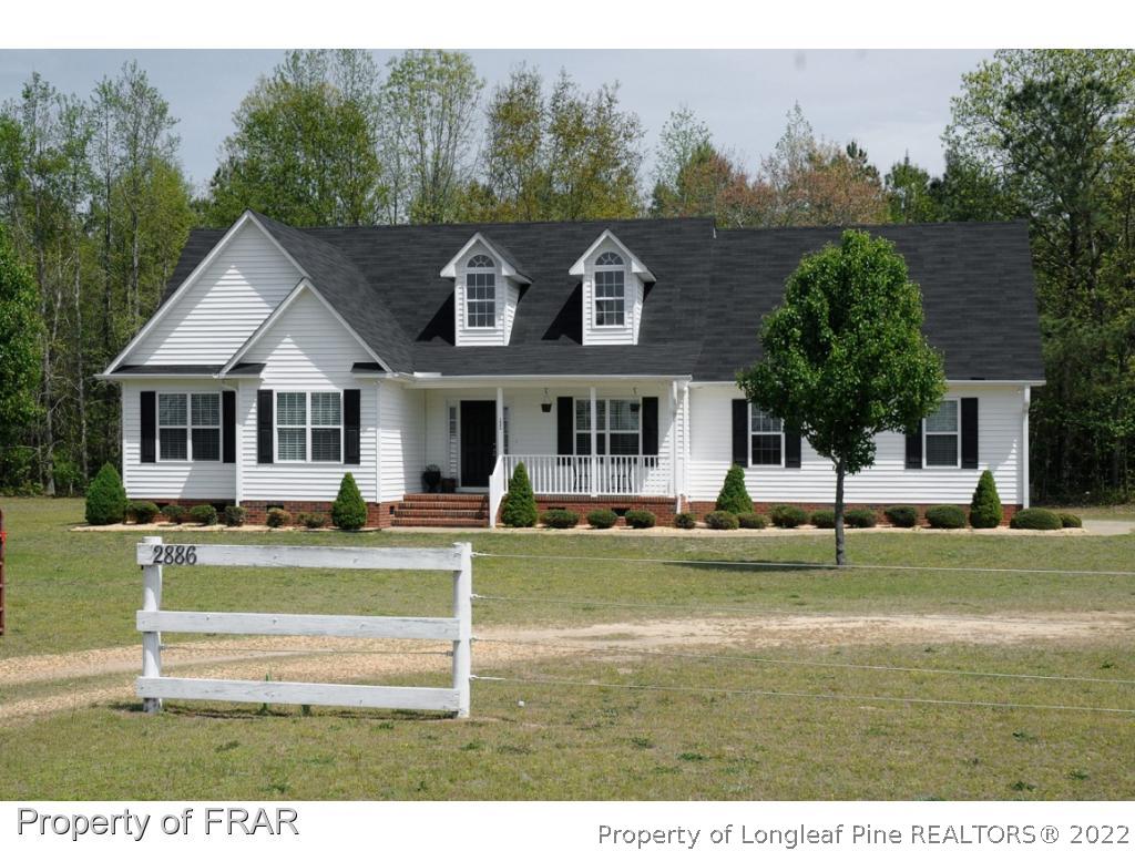 2886 Wade-Stedman Road Stedman, NC 28391 - Photo 2 of 26 a front view of a house with a yard table and chairs