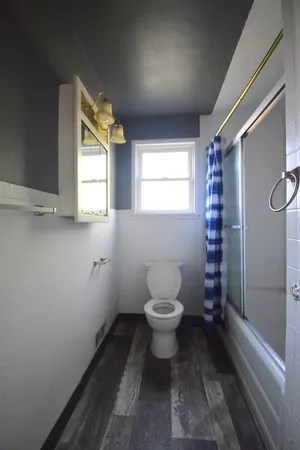 a bathroom with a toilet sink and a shower