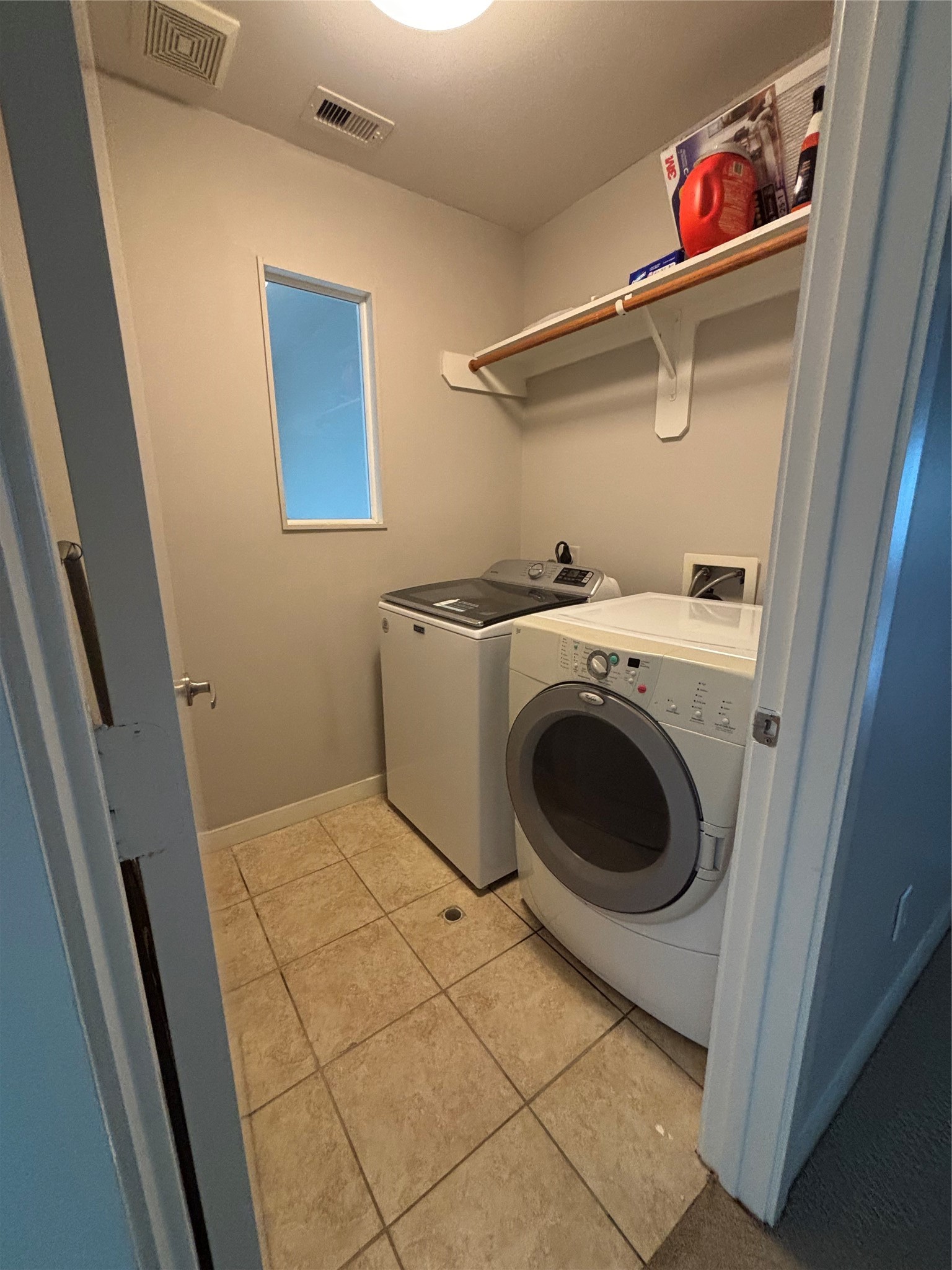 6016 Truro Street Houston, TX 77007 - Photo 21 of 26 Convenient third-floor laundary room with full-size washer and dryer connections, shelving, and easy access to the primary suite.