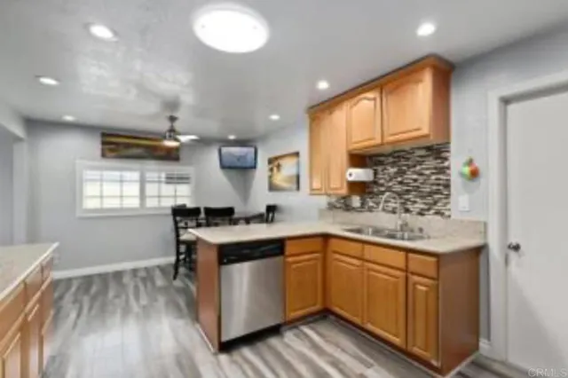 a kitchen with a sink window and cabinets