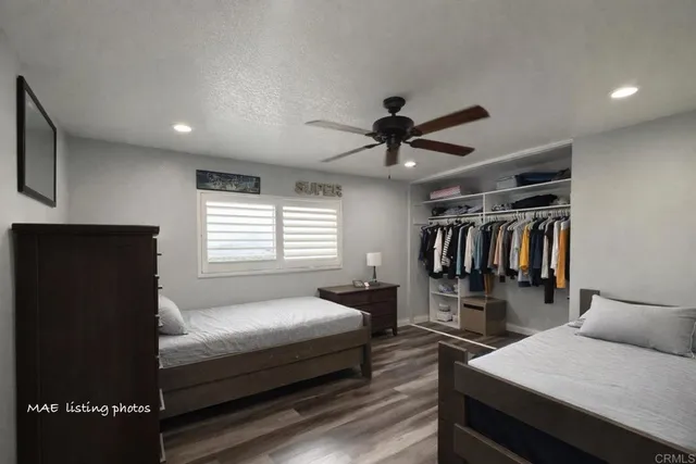 a bedroom with a bed and a ceiling fan