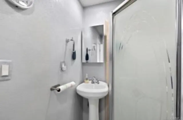 a bathroom with a sink a mirror and shower