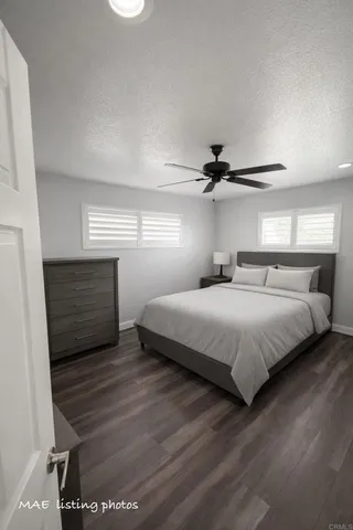 a bedroom with a bed a mirror and a window