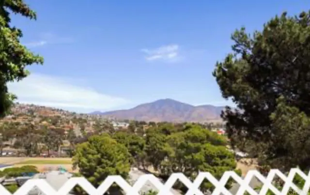 a view of a city with lush green forest