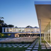 a view of swimming pool with lawn chairs and plants
