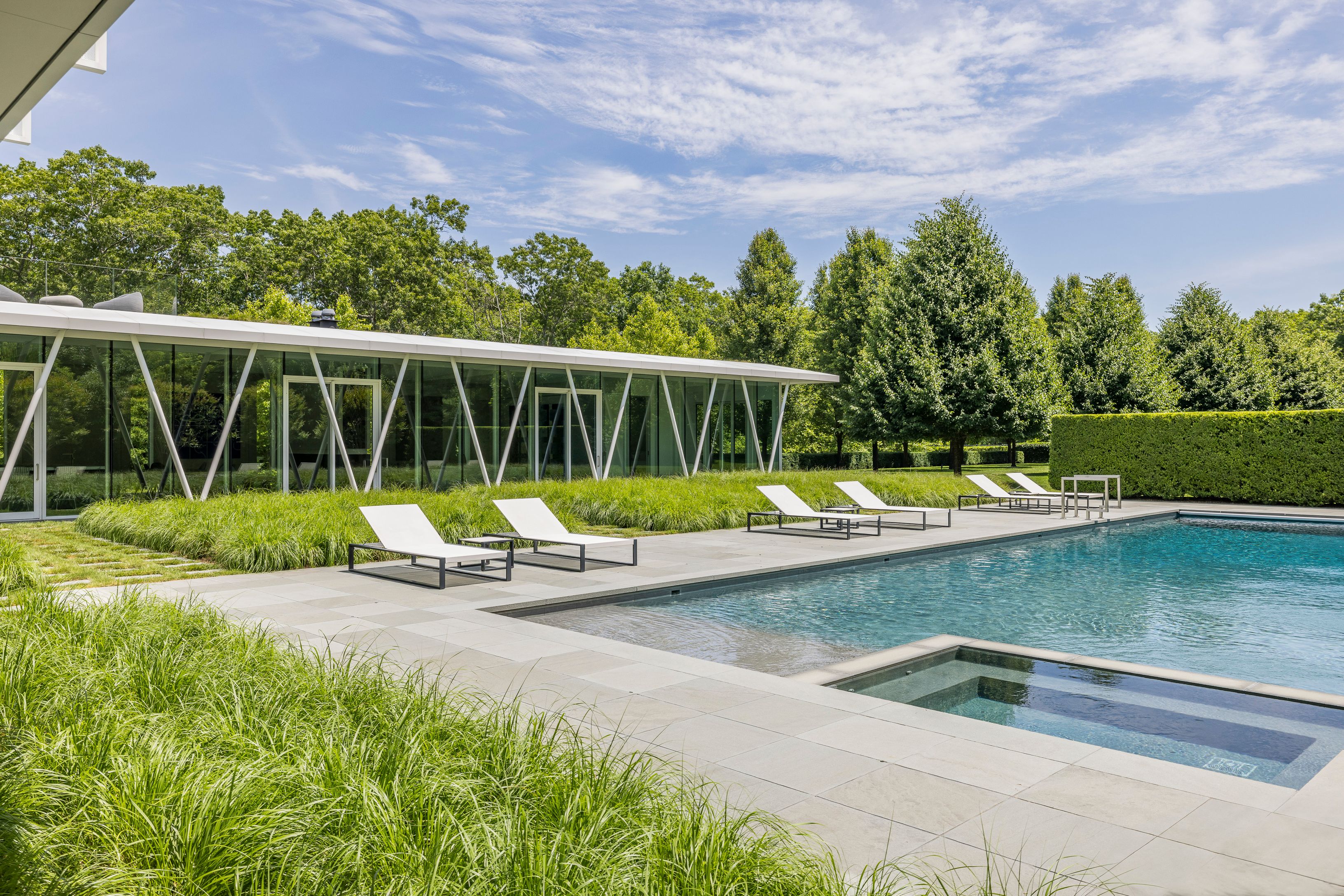 13 Terrys Trail East Hampton, NY 11937 - Photo 13 of 51 a view of a swimming pool with a lounge chair