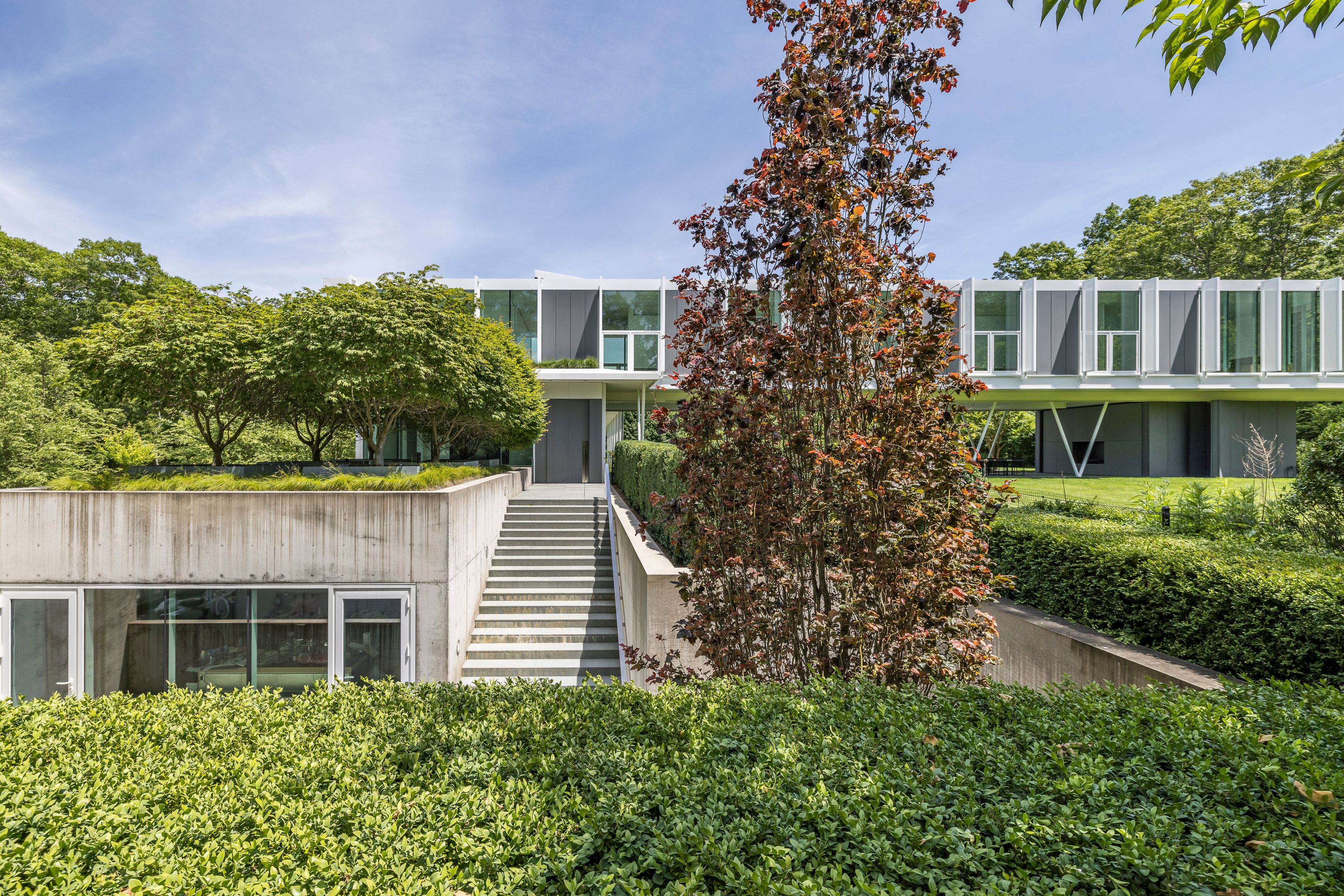 13 Terrys Trail East Hampton, NY 11937 - Photo 19 of 51 front view of a house with a yard