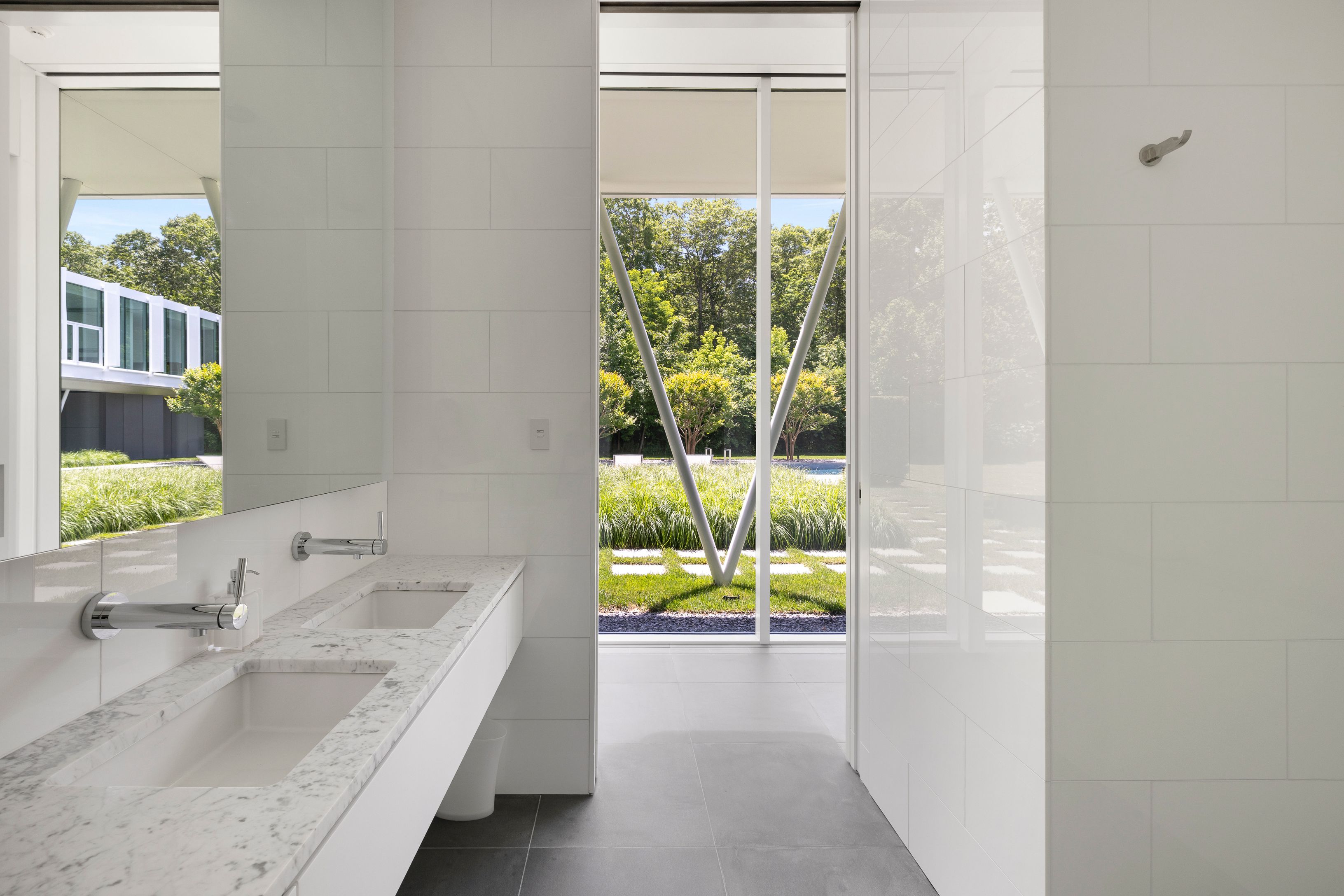 13 Terrys Trail East Hampton, NY 11937 - Photo 28 of 51 a bathroom with a sink and a large mirror