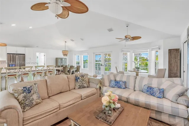 a living room with furniture and kitchen view